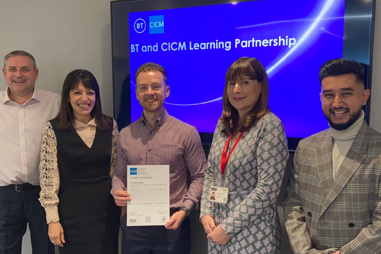 Group of professionals with one professional holding a certificate from the Chartered Institute of Credit Management