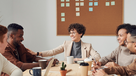 A team surrounding a table with post-it notes