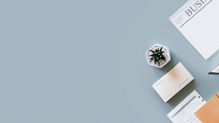 Desk with paper and plant.png